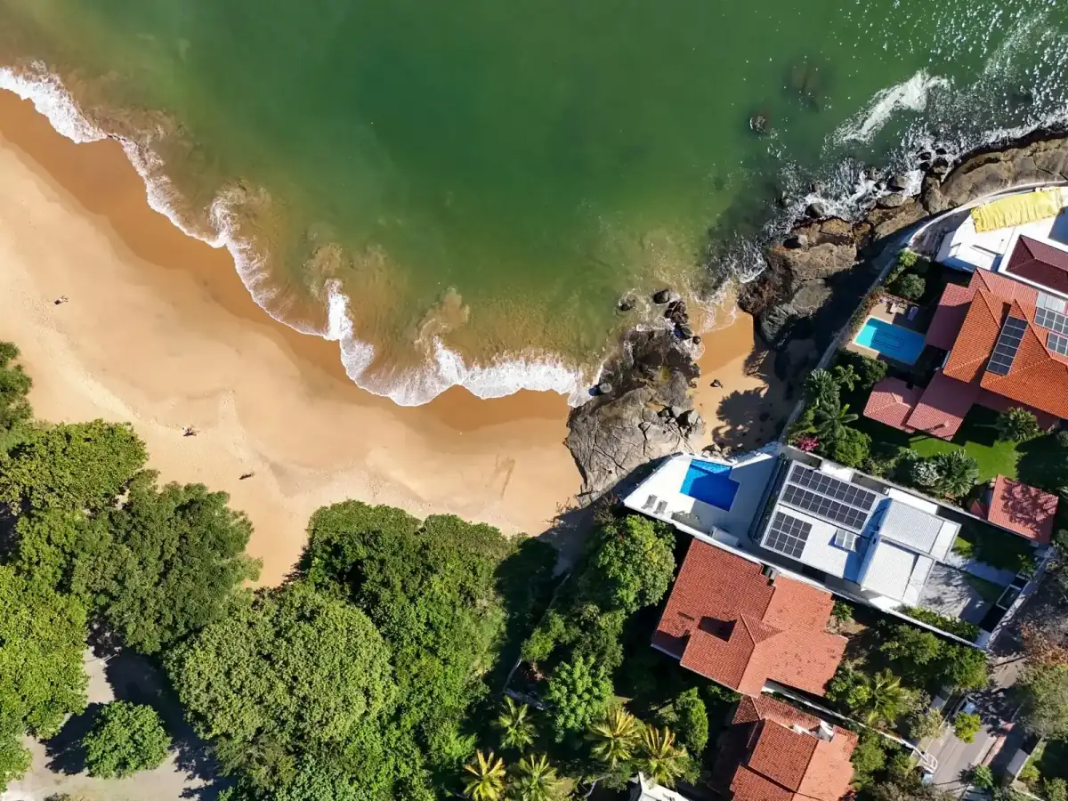 Oceanfront rooftops above a summer shoreline
