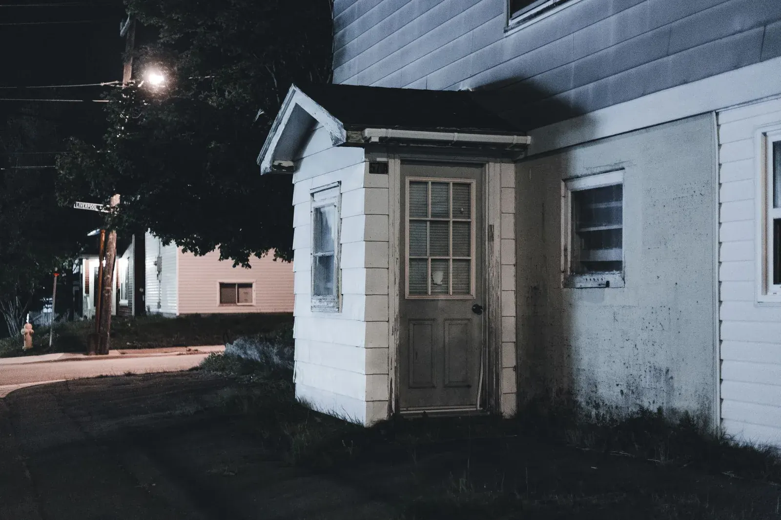 A house at night with the porch light on