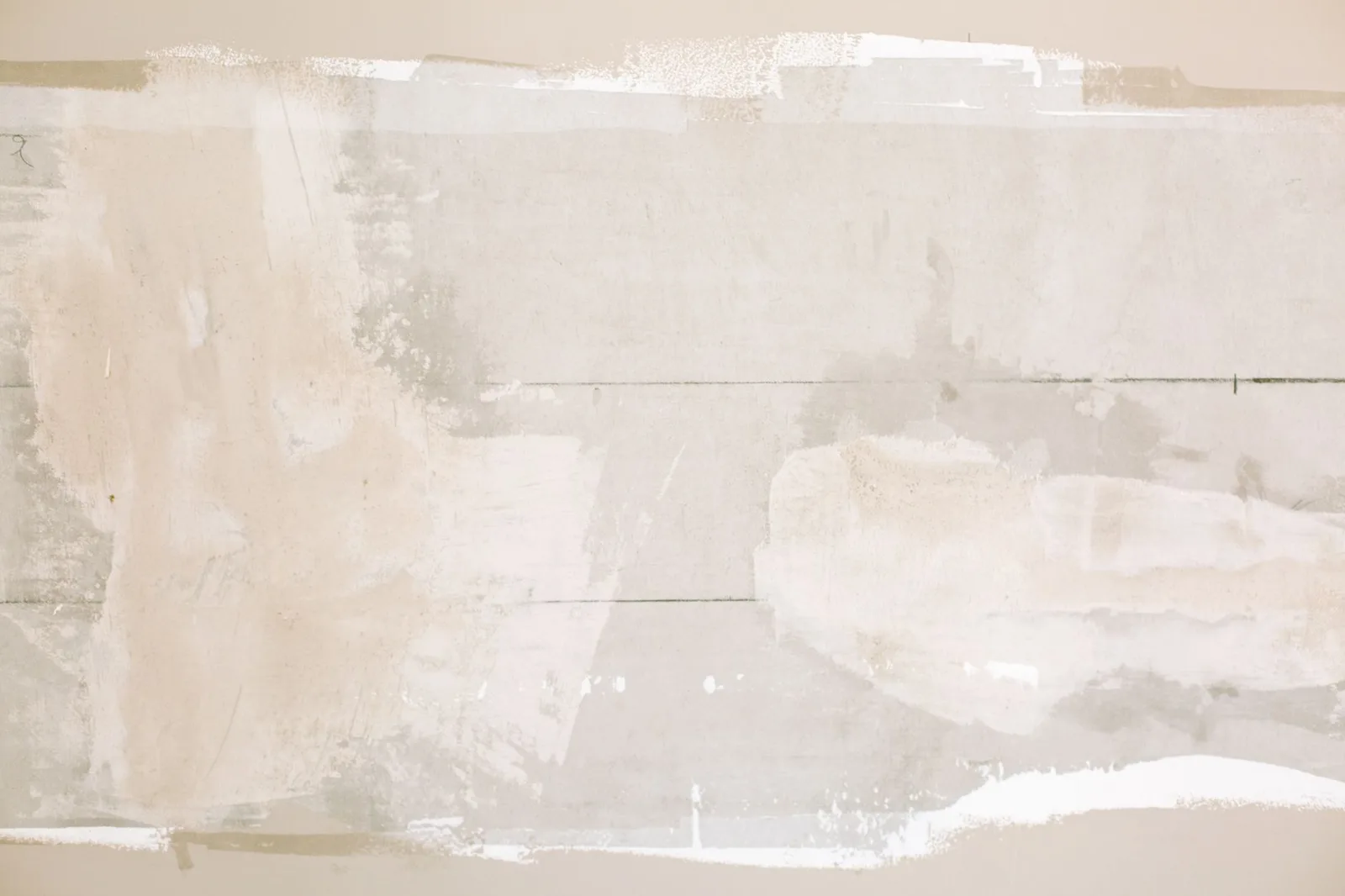 Trowel smoothing wet plaster on a wall