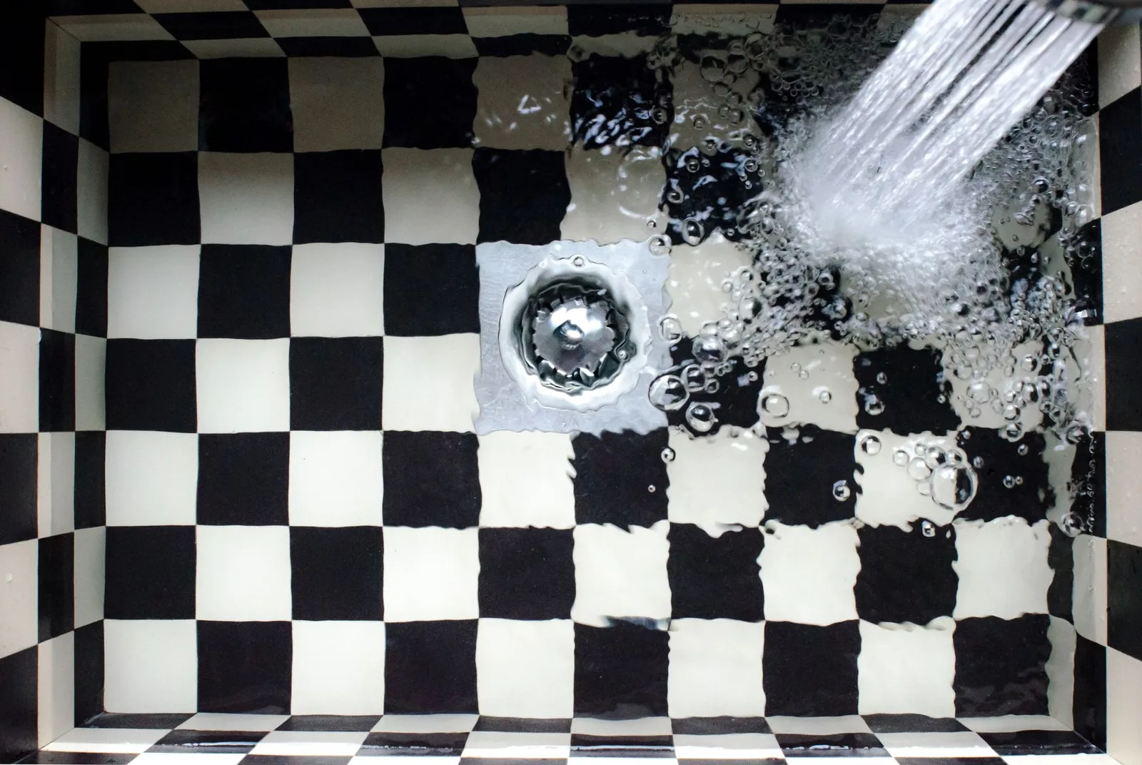 Water running into a bathroom sink drain