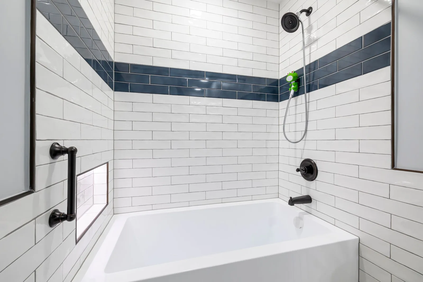 Tiled bathroom wall around a bathtub